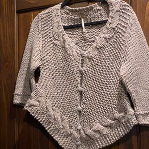Unique open knit sweater with gingham buttons.